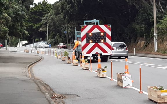 Council contractors remove a DIY protected cycle path in Berhampore, Wellington.