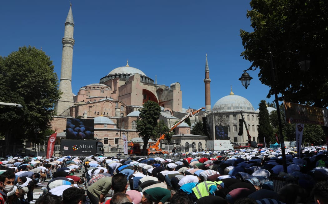 People wait for the first official Friday prayers to start outside Hagia Sophia Mosque on July 24, 2020 in Istanbul, Turkey.