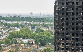 The charred remains of clading are pictured on the outer walls of the burnt out shell of the Grenfell Tower block