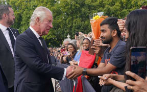 King Charles III greets members of the public waiting in the crowd upon arrival Buckingham Palace in London, on September 10, 2022, a day after Queen Elizabeth II died at the age of 96.
