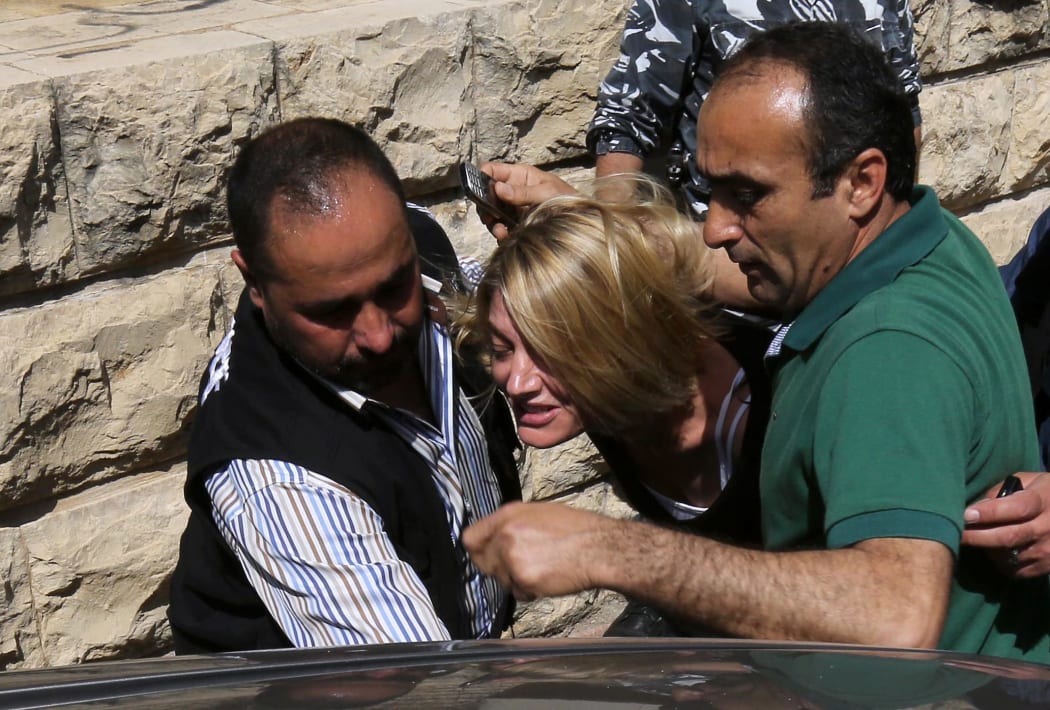 Australian TV reporter Tara Brown is escorted from a Lebanese courtroom.