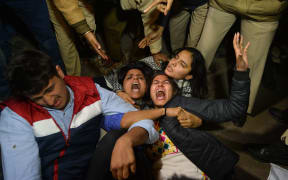 Indian demonstrators shout slogans as they resist arrest at a rally to protest the release of a juvenile rapist.
