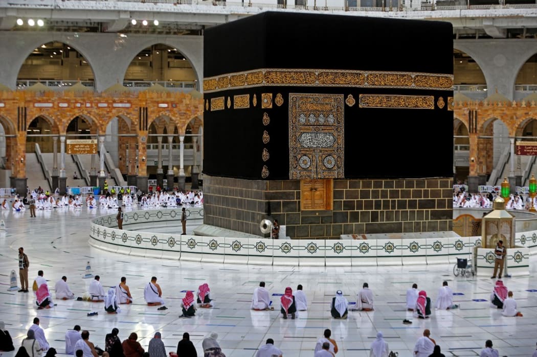 Worshippers perform the al-Adha prayers on the first day of the feast around the Kaaba, Islam's holiest shrine, at the Grand mosque in the holy Saudi city of Mecca, on July 20, 2021. - The Eid al-Adha,marks the end of the  Hajj to the Saudi holy city of Mecca