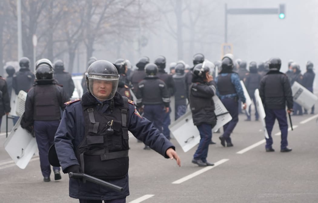 Riot police officers patrol in a street as unprecedented protests over a hike in energy prices spun out of control in Almaty on January 5, 2022.