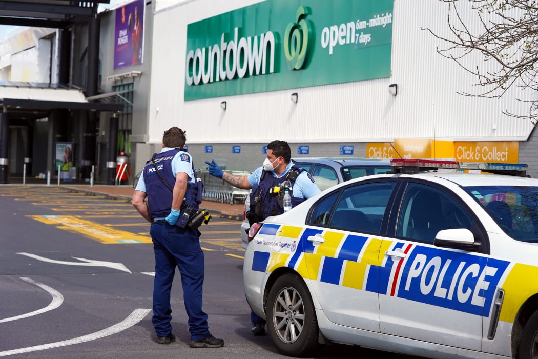 Police keep watch outside the Countdown supermarket at LynnMall.