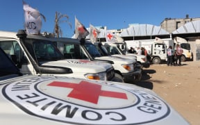 Red Crescent vehicles and refrigerated trucks are parked at the Nasser hospital in Khan Yunis in the southern Gaza Strip on October 15, 2025, after transporting the bodies of Palestinians that had been in Israeli custody.