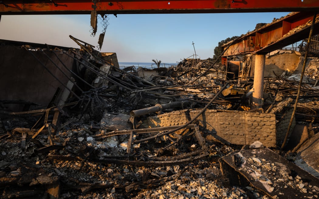 The rubble of apartments overlooking the ocean, destroyed in the Palisades Fire, are seen in the Pacific Palisades neighborhood of Los Angeles, California, on January 10, 2025. Massive wildfires that engulfed whole neighborhoods and displaced thousands in Los Angeles have killed at least 10 people, authorities said, as California's National Guard soldiers readied to hit the streets to help quell disorder.
News of the growing toll, announced late Thursday January 9 by the Los Angeles County Medical Examiner, came as swaths of the United States' second-largest city lay in ruins. (Photo by Zoë Meyers / AFP)