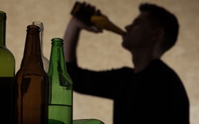 A teenager drinking beer.