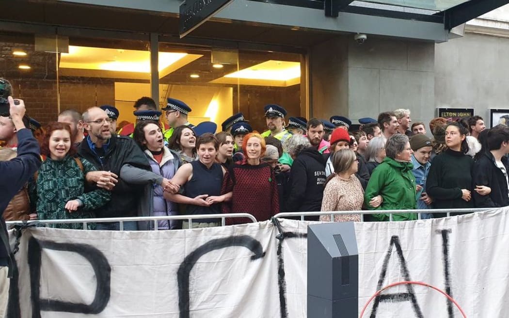 The barricade around the protesters is back in place and more than 20 Minerals Forum delegates are waiting outside the Glenroy Auditorium entrance