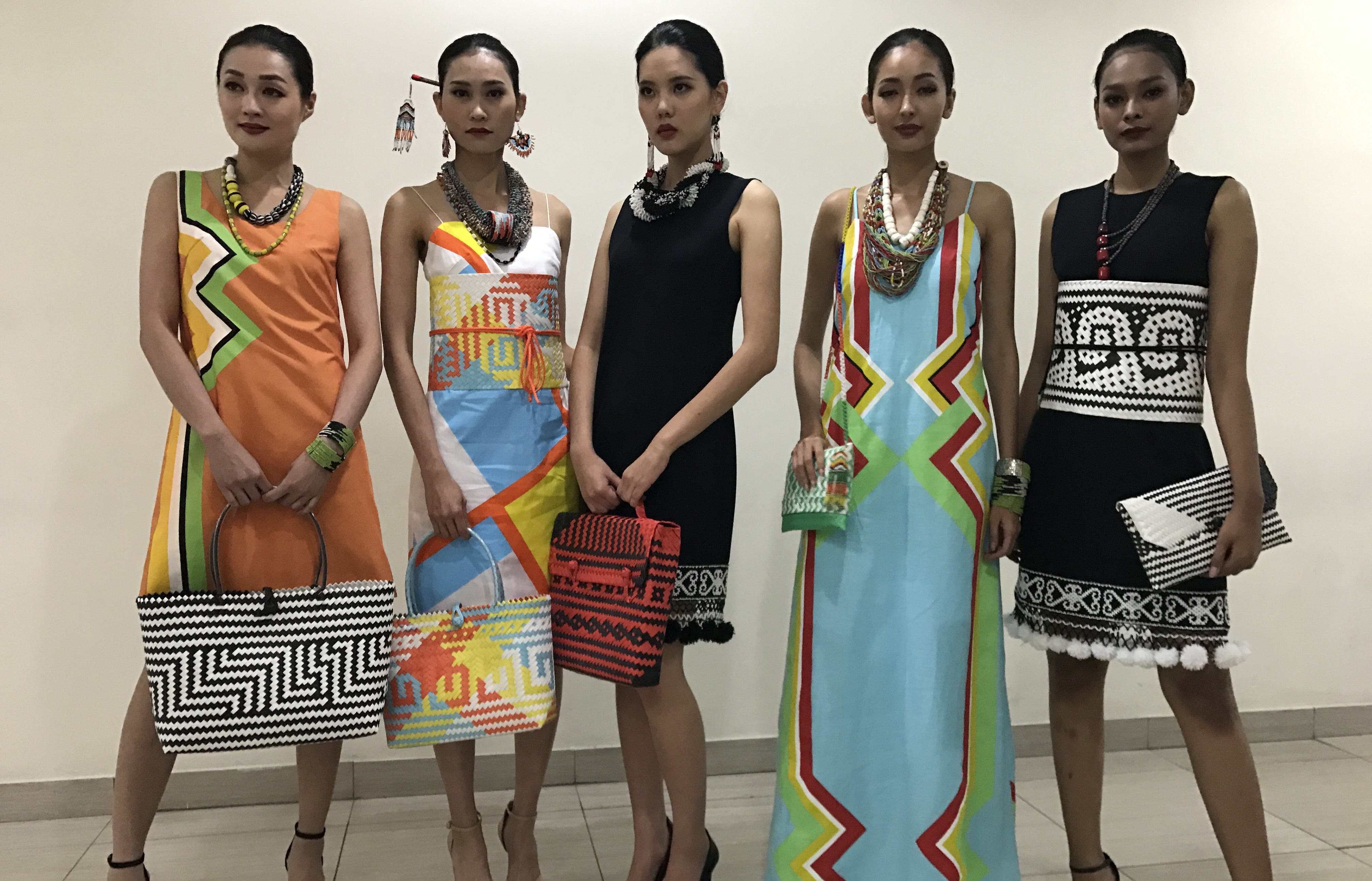 Models showcase some of the Penan tribe's woven products. Borneo Bags business.