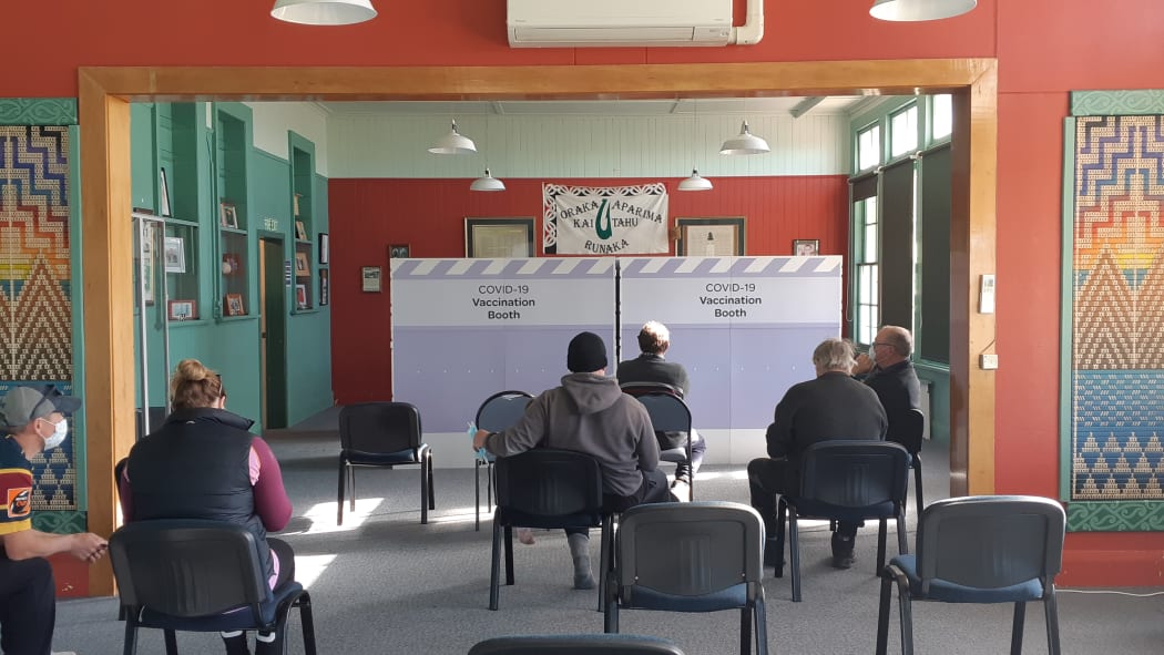 Members of the public line up for vaccines in the small Southland town of Colac Bay.