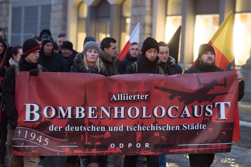 Right-wing extremists hold up a banner reading 'Alliierter Bombenholocaust' (lit. 'Allied Bombing Holocaust') during a so-called funeral march in Dresden on 11 February 2017.