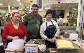 Mandy Asadpour, left, serves Iranian food at the Sepahan Kitchen stall.