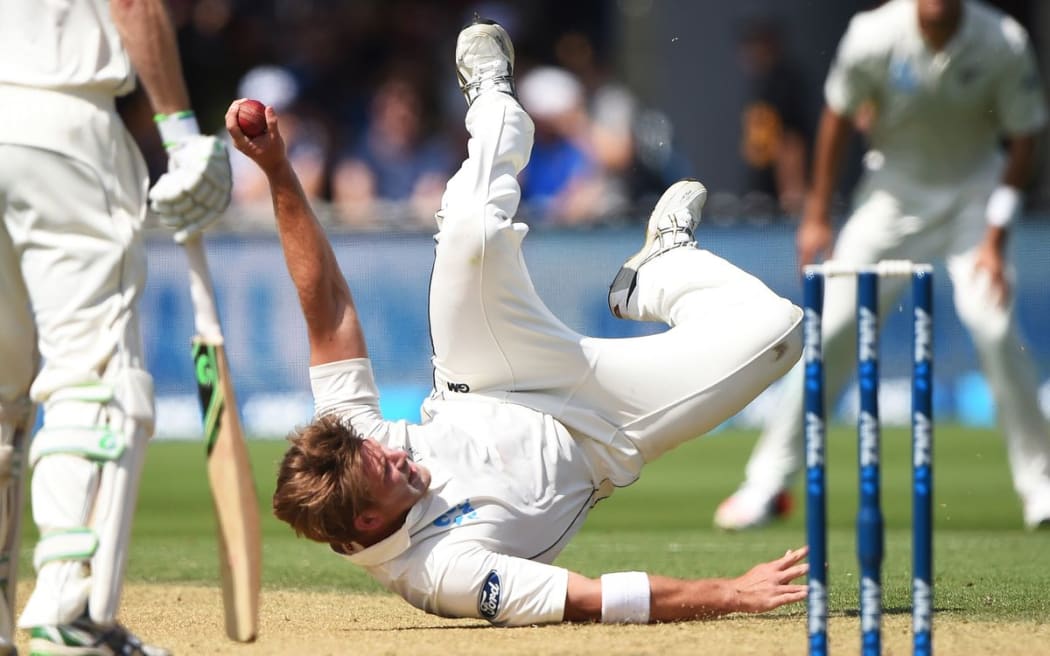 Corey Anderson takes a spectacular catch to dismiss Nathan Lyon, day 3, 1st Test, Basin Reserve, Wellington, Sunday 14 February 2016. Copyright photo: Andrew Cornaga / www.photosport.nz