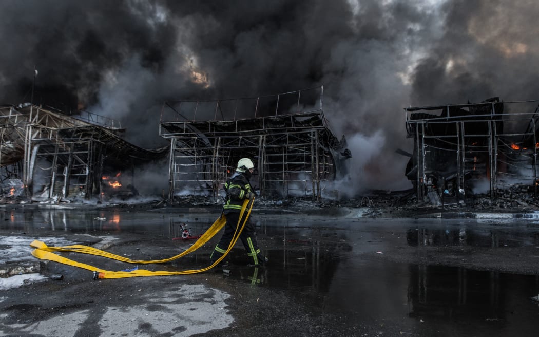 KHARKIV, UKRAINE - MARCH 16: Firefighters try to extinguish a fire broke out at the Saltivka construction market, hit by 6 rounds of Russian heavy artillery in Kharkiv, Ukraine on March 16, 2022.