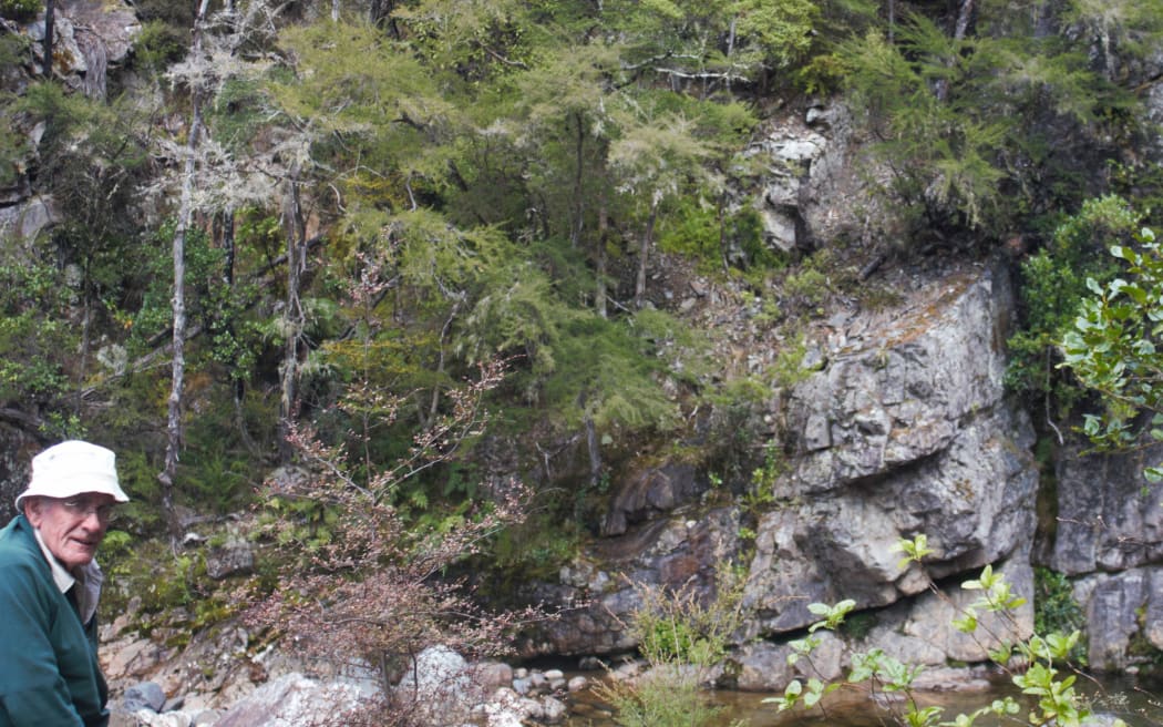 Geologist Chris Adams with Wangapeka sandstone, near Tākaka in northwest Nelson, containing evidence of Zealandia’s ancient origins.