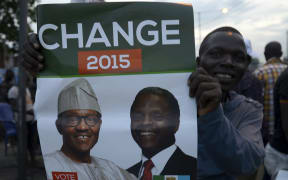 A supporter of the All Progressives Congress (APC) celebrates the election win.
