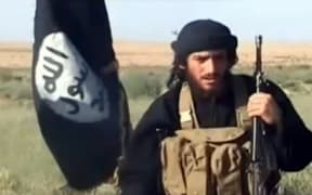 A screenshot from a video uploaded to YouTube in 2012 shows Abu Muhammad al-Adnani speaking next to an Islamic State flag at an undisclosed location.