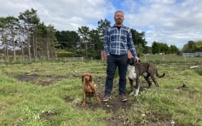Nathan Hogg says the waiting game he's playing with the council has pushed him to breaking point. He is pictured on the one acre of land he's trying to subdivide in Colac Bay
