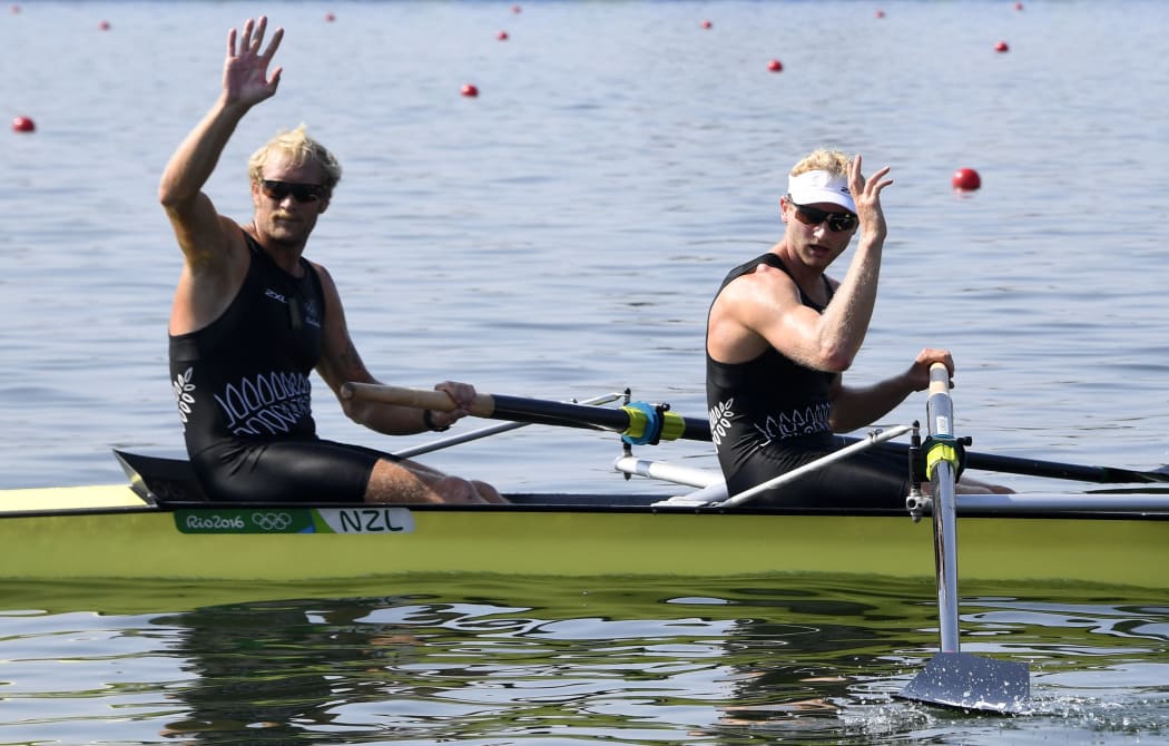Hamish Bond and New Zealand's Eric Murray (L) wave after the Men's Pair Semifinal rowing competition