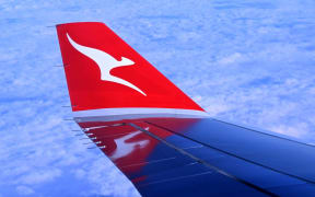 A photo taken on August 20, 2023 shows the wing-tip of a Qantas Airbus A330 descending to land at Sydney´s Kingsford Smith Airport. (Photo by William WEST / AFP)