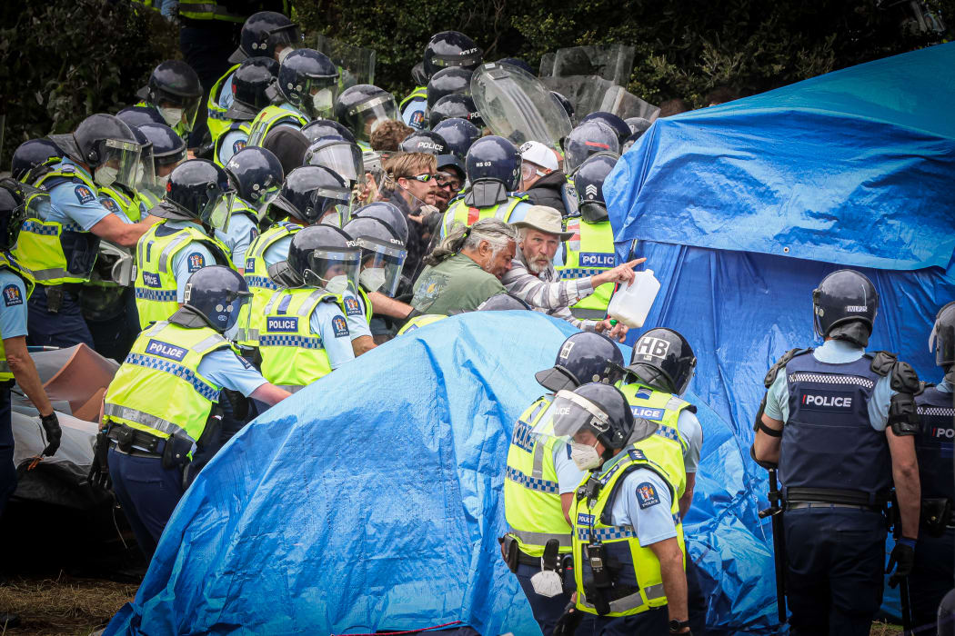 'Can we go this way?' Two protesters make a quick exit as police push through to remove the first area of tents.