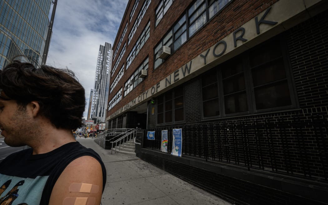 (FILES) In this file photo taken on August 17, 2022, a man, who wished to remain anonymous, displays his arm where he received a polio vaccination, outside a health clinic in Brooklyn, New York on August 17, 2022. - Since the first polio case was identified in July in New York's Rockland County, the disease has been detected in New York City sewage, suggesting the virus is spreading. The developments are leading experts to fear that polio, once one of the most feared diseases in America but now endemic to just a couple of developing countries, may wreak devastation stateside again. "I had considered it a virus that was on its way to extinction," John Dennehy, a virologist at the City University of New York, told AFP. (Photo by Ed JONES / AFP)