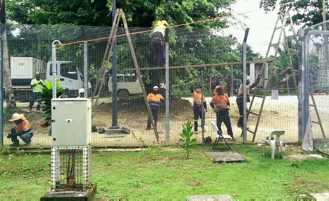 Workers taking down the fences at the Manus Island detention centre.