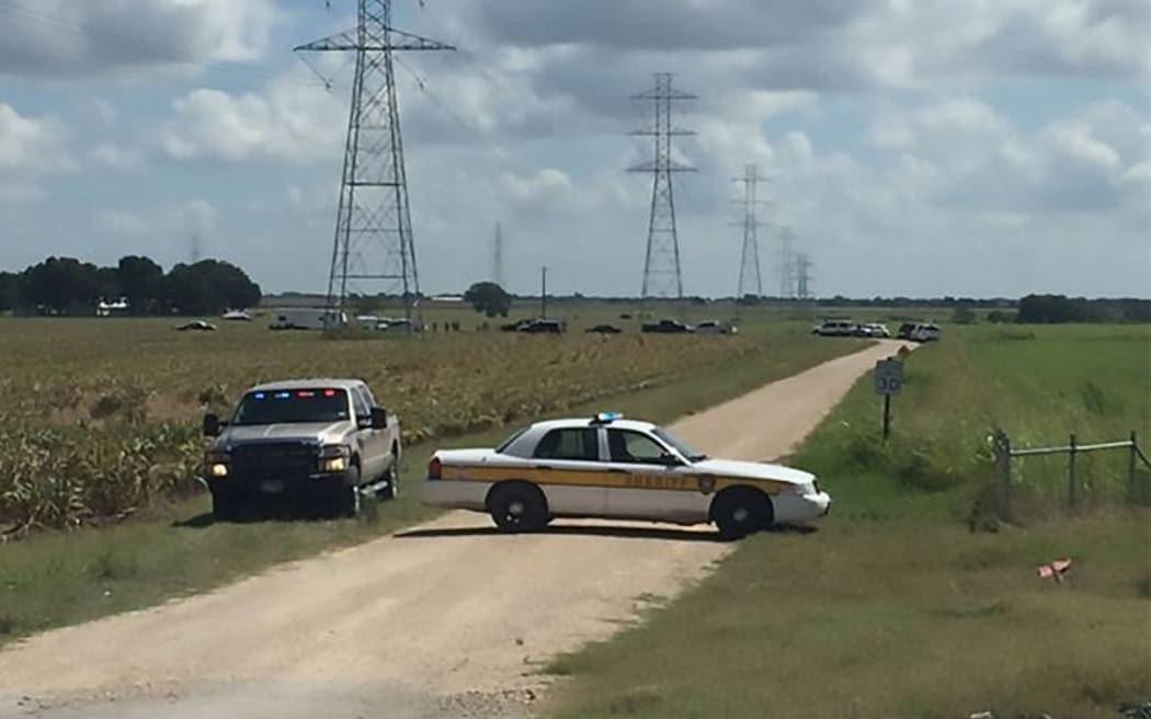 a police vehicle blocking a road where a hot air balloon crashed near Lockhart, Texas, July 30, 2016. Sixteen people are feared to have died