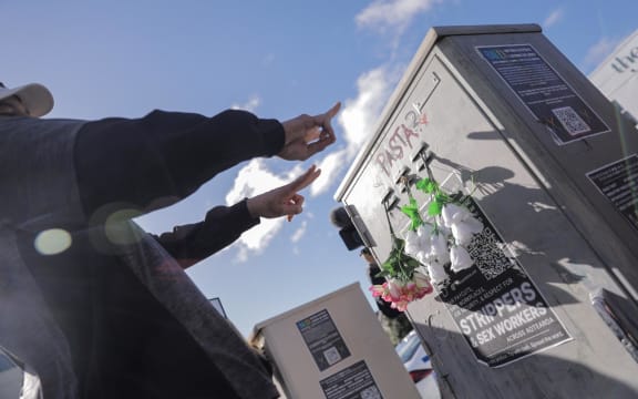 Loafers Lodge resident Chris, last name unknown, lays flowers near the building for his friends he lost in the fire on 16 May, 2023.