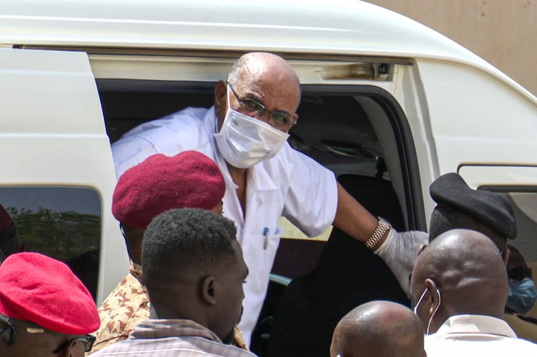 Sudan's ousted President Omar al-Bashir disembarking from a vehicle upon arriving at the courthouse to attend his trial along with 27 other co-accused, in the capital Khartoum.