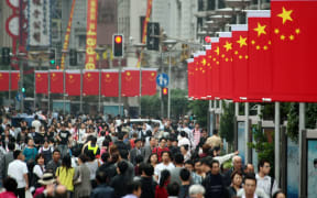 Tourists crowd the Nanjing Road shopping street in Shanghai, China, 30 September 2011. (Photo by Weng lei / Imaginechina / Imaginechina via AFP)