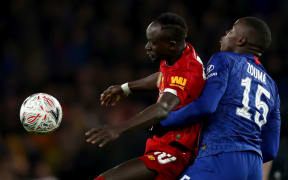 Kurt Zouma of Chelsea competes for the ball with Sadio Mane of Liverpool.