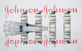 A file photo taken on November 17, 2020 shows vials with Covid-19 Vaccine stickers attached and syringes with the logo of US pharmaceutical company Johnson & Johnson in London.