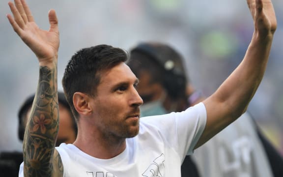 Paris Saint-Germain's Argentinian forward Lionel Messi waves hands to the supporters during a presentation ceremony prior to the French L1 football match between Paris Saint-Germain and Racing Club Strasbourg at the Parc des Princes stadium in Paris on August 14, 2021.