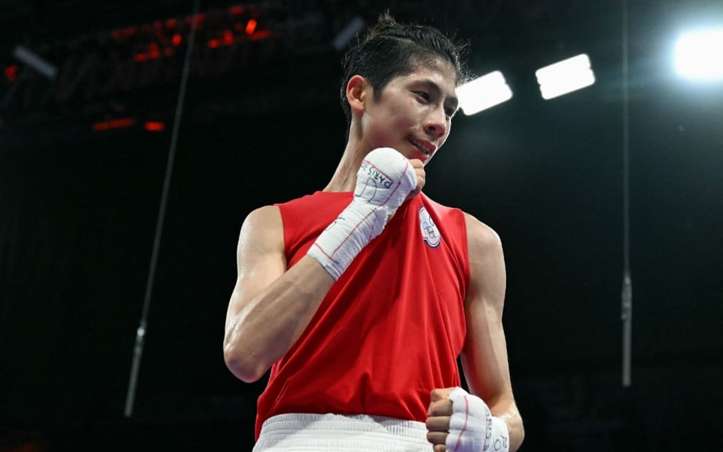 Taiwan's Lin Yu-ting reacts after beating Bulgaria's Svetlana Kamenova Staneva (Blue) in the women's 57kg quarter-final boxing match during the Paris 2024 Olympic Games at the North Paris Arena, in Villepinte on August 4, 2024. (Photo by MOHD RASFAN / AFP)