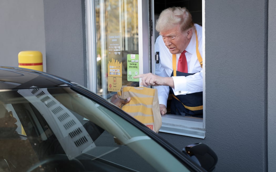 FEASTERVILLE-TREVOSE, PENNSYLVANIA - OCTOBER 20: Republican presidential nominee, former U.S. President Donald Trump works the drive-through line as he visits a McDonald's restaurant on October 20, 2024 in Feasterville-Trevose, Pennsylvania. Trump is campaigning the entire day in the state of Pennsylvania. Trump and Democratic presidential nominee Vice President Kamala Harris continue to campaign in battleground swing states ahead of the November 5th election.   Win McNamee/Getty Images/AFP (Photo by WIN MCNAMEE / GETTY IMAGES NORTH AMERICA / Getty Images via AFP)