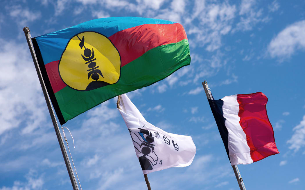 Kanak and French flags on Ouvea island.