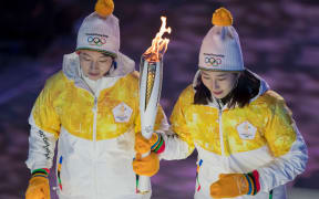 The Olympic Flame is carried up to the cauldron to be lit by South Korean athletes.