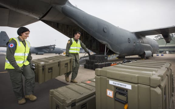 released by the Royal Australian Air Force on December 11, 2019 shows Flight Lieutenant Danielle Polgar (left) and Squadron Leader Shamus Shepherd  loading a C-130J Hercules prior to a mission to repatriate Australians at the Royal Airforce Base in Richmond.
