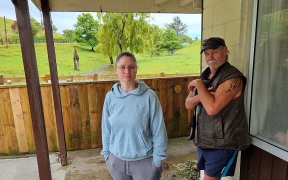 Alicia Field and Chris Pirret stand in front of the stream that turned into a torrent.