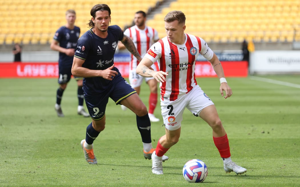 Melbourne City's Scott Galloway eludes Oskar Zawada of the Wellington Phoenix during their A-League game.