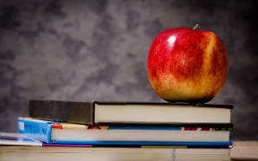 Stock image of school books and apple