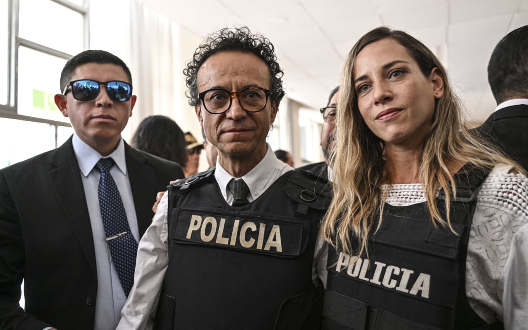 Journalist and presidential candidate for the Construye party, Christian Zurita, centre, is pictured with his running mate, vice presidential candidate Andrea Gonzalez, right, in Quito on 13 August 2023.