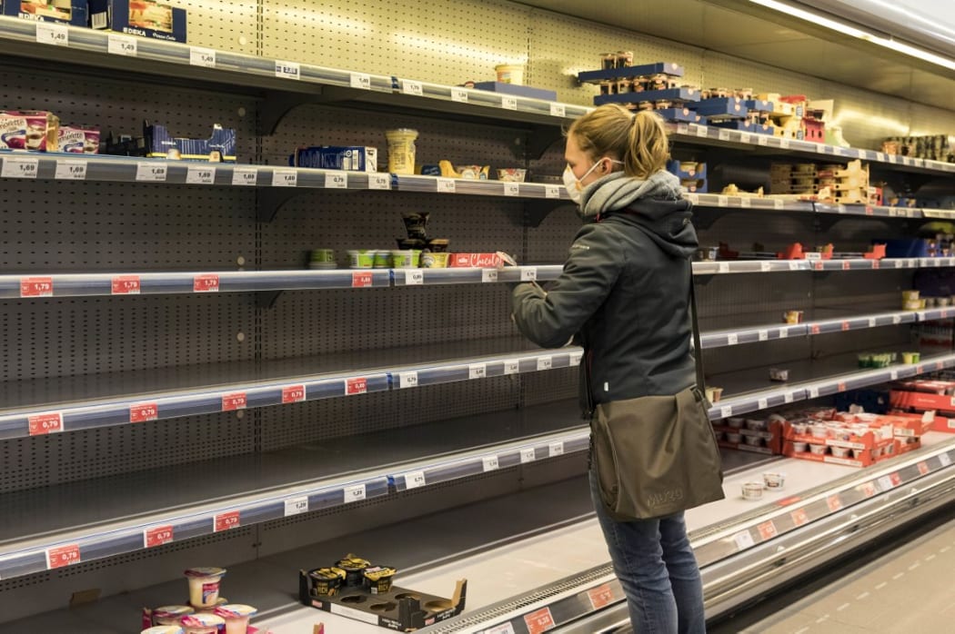 Empty food whiteboard shelves in a supermarket. Berlin,