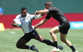 Fiji captain Jerry Tuwai is caught by the New Zealand defence.
