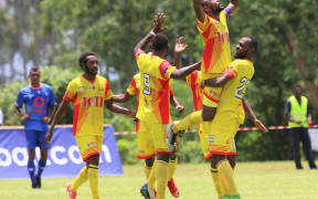 Lae City captain Raymond Gunemba is embraced after scoring against Lautoka FC.