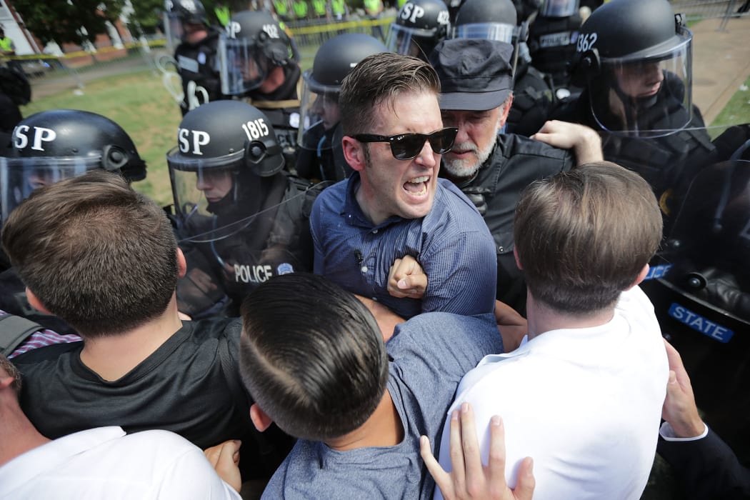 White nationalist Richard Spencer (C) and his supporters clash with Virginia State Police in Emancipation Park after the "Unite the Right" rally was declared an unlawful gathering in Charlottesville, Virginia.