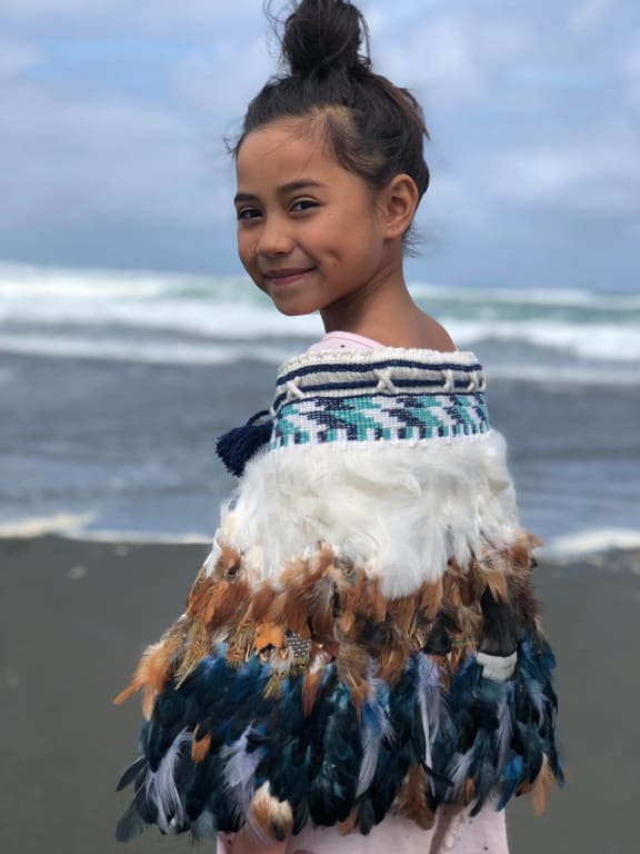 Child wearing korowai