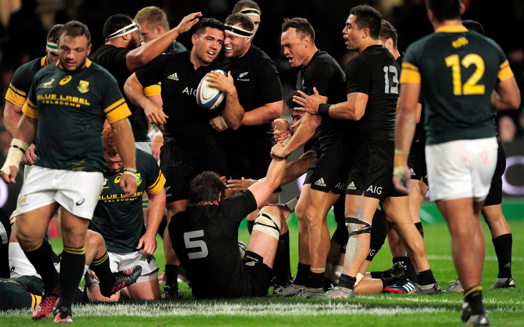 Codie Taylor is congratulated by his All Blacks team mates after scoring against Springboks in Durban 2016.